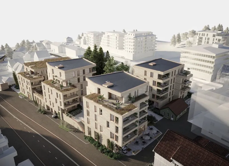 Røa X: boligbygg i lys tegl med takterrasser langs en bygate, sett ovenfra